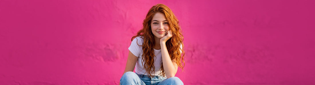 Red head teenager against hot pink background